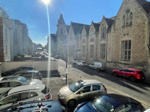a group of cars parked on a city street at Studio Flat Central Cheltenham Parking off road in Cheltenham