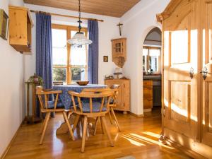 a kitchen and dining room with a table and chairs at Landhaus Albrecht in Mittenwald