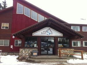 a store front of a red building in the snow at Fernie Slopeside Lodge in Fernie