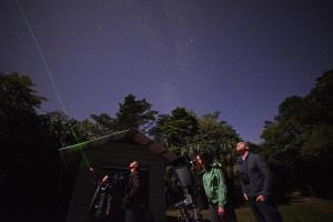 a group of people standing in front of a starry sky at Thala Beach Nature Reserve in Port Douglas