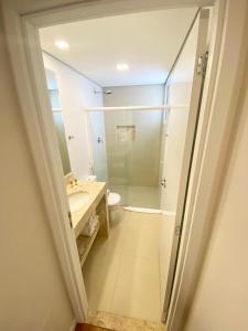 a bathroom with a shower and a sink and a toilet at Legacy Hotel Guaratinguetá - Ao lado de Aparecida -SP in Guaratinguetá