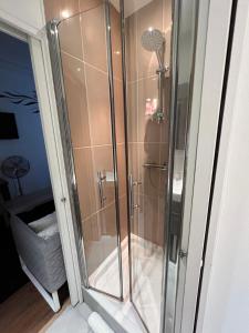 a shower with a glass door in a bathroom at Studio Alésia - HALA PARIS in Paris