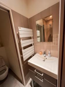 a bathroom with a sink and a toilet at Studio Alésia - HALA PARIS in Paris
