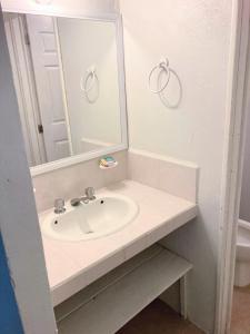 a bathroom with a sink and a mirror at Hotel Casa Blanca in El Oro de Hidalgo