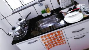 a kitchen counter top with a sink and a counter top at LoftStudio16 Próximo a Fiat a Br381 e Via expressa in Betim
