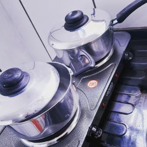 two pots and pans sitting on top of a stove at LoftStudio16 Próximo a Fiat a Br381 e Via expressa in Betim
