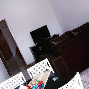 a living room with two chairs and a television at LoftStudio16 Próximo a Fiat a Br381 e Via expressa in Betim
