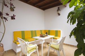 a room with a table and chairs and a couch at Villa Remedios in Teguise