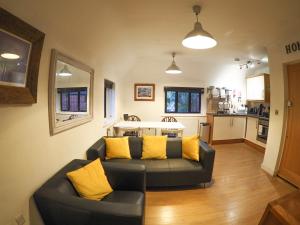 a living room with a couch and a kitchen at 2 Ringles Place in Uckfield