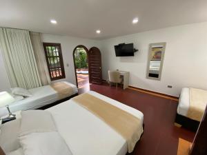 Postel nebo postele na pokoji v ubytování Hotel Casa Colonial