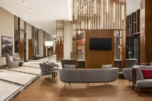 a lobby with chairs and a flat screen tv at Ramada by Wyndham Rize Findikli in Rize
