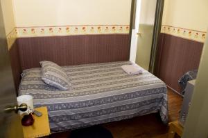 Postel nebo postele na pokoji v ubytování Hostal Residencia Blest Gana