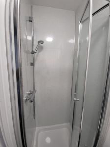 a shower with a glass door in a bathroom at MM Sure Stay Accommodation - NG1 in Nottingham
