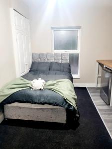 a bed sitting in a room with a window at MM Sure Stay Accommodation - NG1 in Nottingham