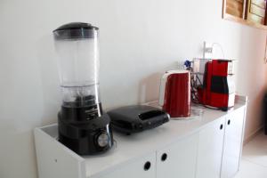 a counter with a blender and other appliances on it at - Belezas do Monte Chalé e Suíte- La na Roça in Monte das Gameleiras