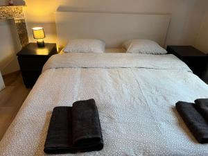 a bedroom with a bed with two pillows on it at Cosy Apartment Merode in Brussels