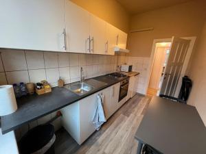 Kuchyň nebo kuchyňský kout v ubytování Cosy Apartment Merode