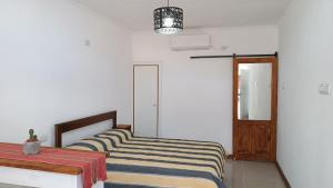 a bedroom with two beds and a table and a window at Caá Guazú in Curuzú Cuatiá