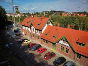 a group of cars parked in a parking lot in front of a building at Pokoje Pod Mniszkiem in Boguszów-Gorce