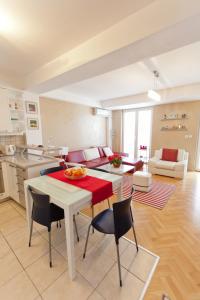 a kitchen and living room with a table and chairs at Tina Apartments in Skopje