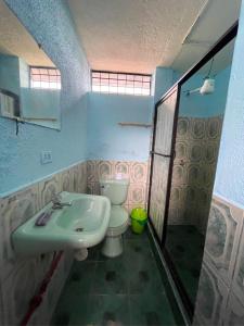 a bathroom with a toilet and a sink at Casa hospedaje Puyo in Puyo