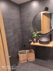 a bathroom with a sink and a mirror at Stodoła Nad Skawą in Sucha Beskidzka