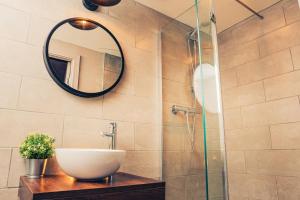 a bathroom with a sink and a mirror at Reubens Congleton in Congleton