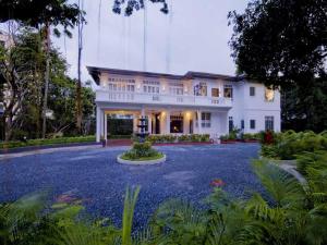 a large white house with a large driveway at The Henry Hotel Manila in Manila