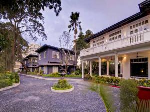 a house with a courtyard in front of a building at The Henry Hotel Manila in Manila