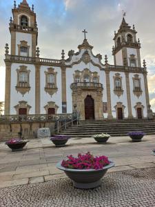 a large church with flowers in front of it at Studios Rossio in Viseu