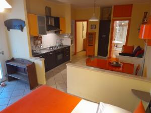 a kitchen with yellow and orange cabinets and a counter top at Mini appartamento vicino Roma in Fiano Romano