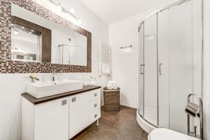a white bathroom with a sink and a shower at ARI Cherry Apartament with Balcony in Arad +41 photos
