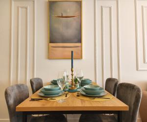 a dining room table with chairs and a picture of a boat at Modern Harmony in Kolašin