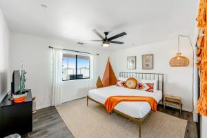 een slaapkamer met een bed en een plafondventilator bij Yucca Dream in Yucca Valley