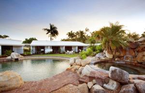 a house with a swimming pool and a resort at Mission Beach Resort in Mission Beach