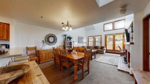 a kitchen and dining room with a table and chairs at Ski In, Ski Out, 3 Bedroom Luxury Residence In The Heart Of Snowmass Village in Snowmass Village