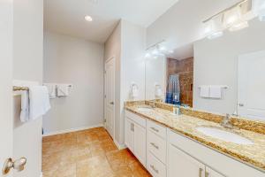 a bathroom with two sinks and a large mirror at Morgan Shores in Port Aransas