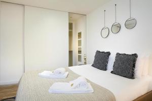 a bedroom with a bed with towels on it at Almoura Ladeira in Évora
