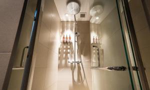 a shower in a bathroom with a glass door at HOTEL RINGS KYOTO in Kyoto