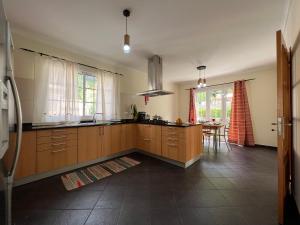 a kitchen with wooden cabinets and a table in it at Briola by AnaLodges in São Vicente