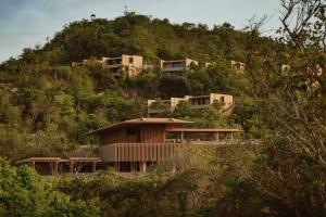 a house on the side of a hill at Four Seasons Resort Tamarindo, México in Cihuatlán