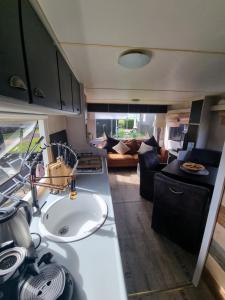 an rv kitchen with a sink and a living room at Meerblick Wattenmeer ,50m vom Meer,Strand 300m in Westerland