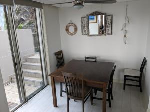 a dining room with a table and chairs at Toowoon Bay Beachfront Apartment in The Entrance