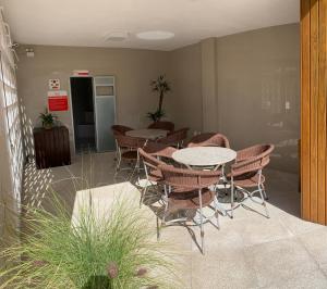 a group of tables and chairs in a room at Hotel Geranius Ingleses in Florianópolis