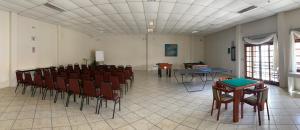 a room with chairs and tables in a room at Hotel Geranius Ingleses in Florianópolis +39 photos