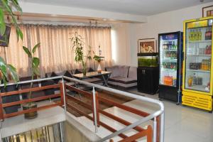 a living room with a couch and a refrigerator at HOTEL GS y GOURMET in Lima