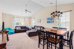 a living room with a table and a couch at Coral Reef Retreat in Sunset Beach
