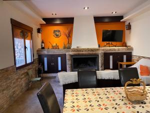 a living room with a table and a fireplace at Casa Rural La Sureña in Ossa de Montiel