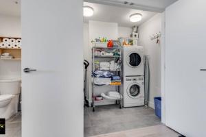 a laundry room with a washer and dryer at Songhees Breeze in Victoria