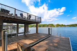 a wooden dock with two chairs on top of the water at Cottage at the Lake in Moneta